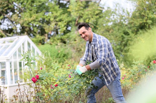 Worker maintaining safe conditions in a garden workspace