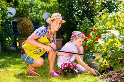 Functional landscape gardening in Elm Park with lawn, patio, and garden lighting